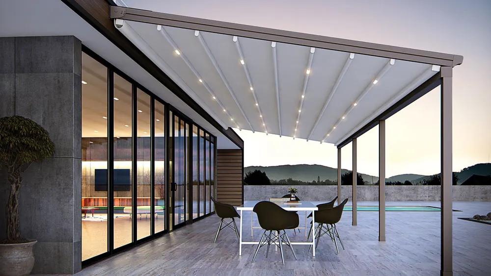 White canopy with integrated lights extended over a glazed facade and a dining table