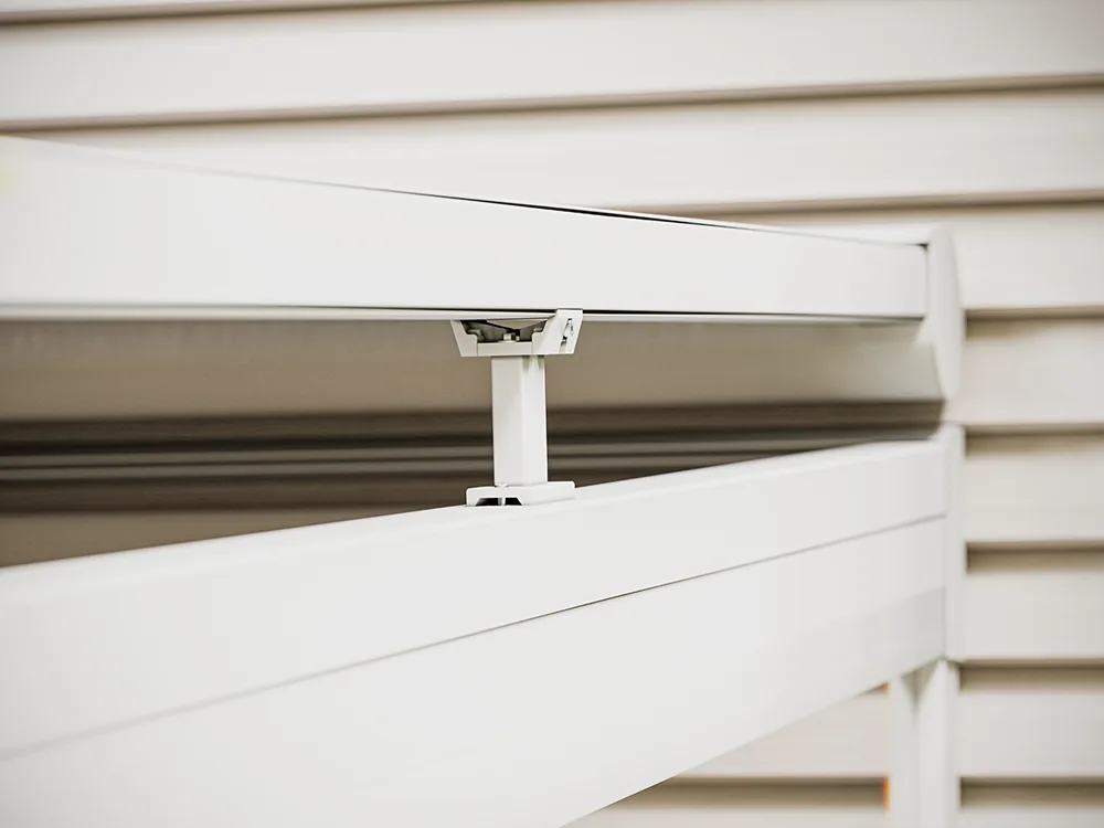 Mounting bracket close-up on a spring ceiling zip screen fixed to a pergola frame