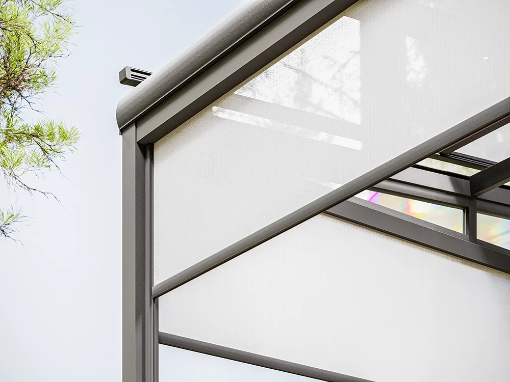 Dark aluminium post and rail profile holding a white vertical zip screen under a glass roof