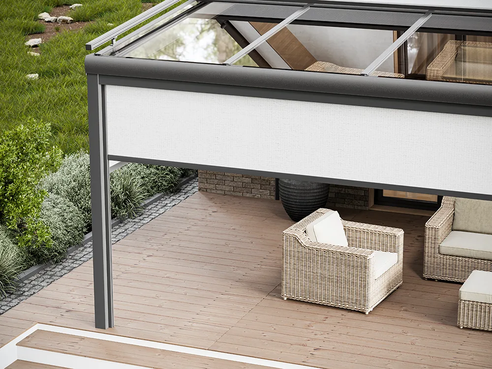 Light vertical zip screen lowered on the open side of a terrace with rattan lounge chairs