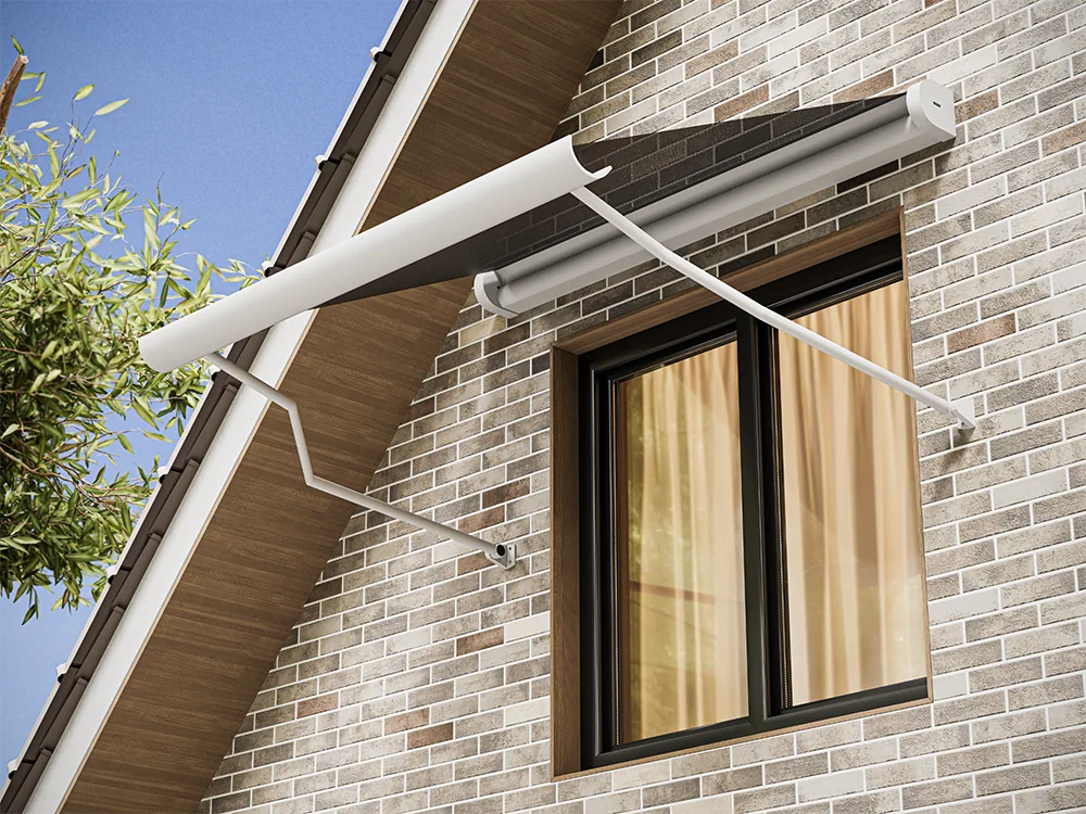 Window awning with light fabric on two slim arms, seen from below on a brick house wall