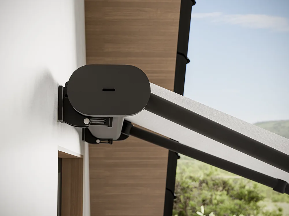 Dark rounded cassette end cap on a wall bracket with a folding arm leading out over a wooden soffit