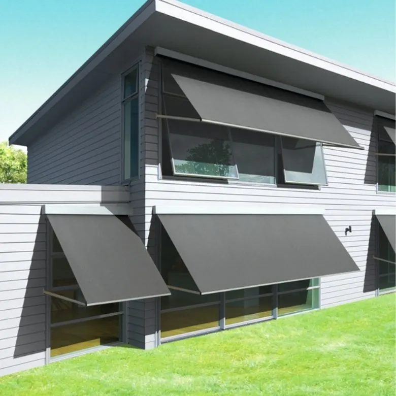 Row of grey window awnings over the windows of a two-storey building with a lawn in front