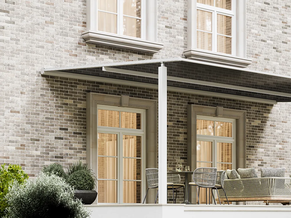 Brick house patio with a pergola and zip screens enclosing one side